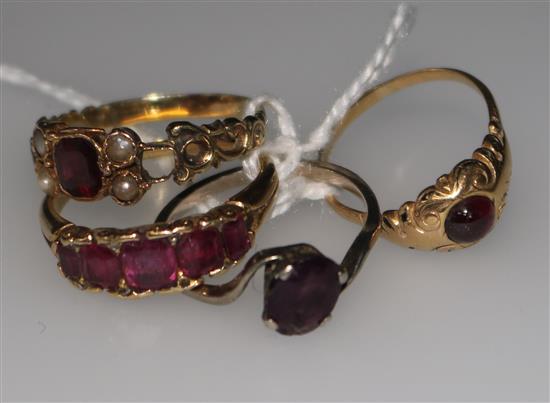 A ruby half-hoop ring in yellow metal setting and three other assorted rings.